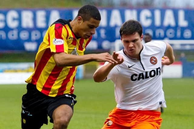 Curtis Good, right, battles for the ball with Partick Thistle's Lyle Taylor. Picture: SNS