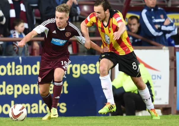 Hearts' Billy King, left, is tightly marked by Partick Thistle's Stuart Bannigan. Picture: SNS
