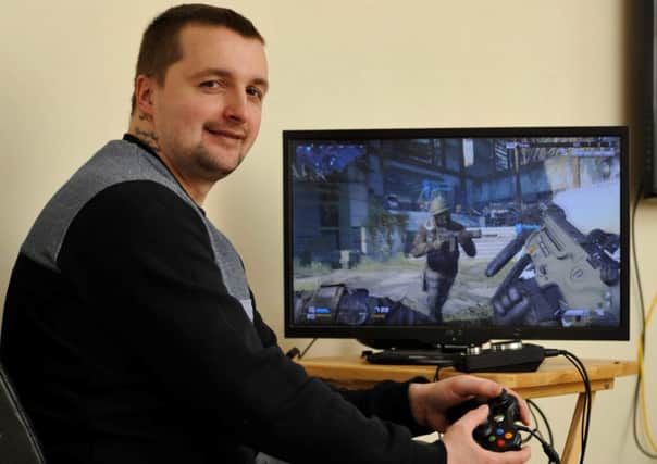 Stay at home dad Peter Potts plays Call of Duty whenever he has spare time. Picture: Hemedia