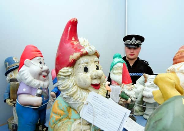 PC Jack Savile keeps a close eye on the gnomes at Banff Police Office. Picture: Hemedia