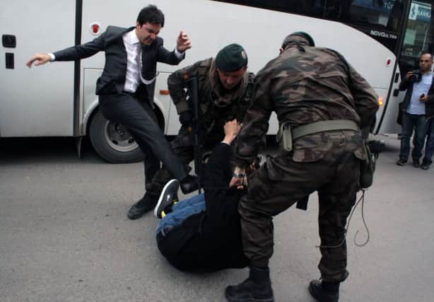 Yusuf Yerkel, an adviser to Turkish prime minister Recep Tayyip Erdogan, is shown kicking a protester. Picture: AP