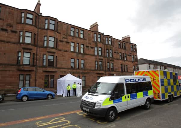 Police forensic officers positioned outside an address on Dumbarton Road in Glasgow. Picture: Hemedia