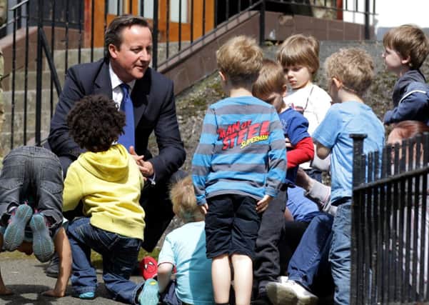 Prime Minister David Cameron outside the Walcheren Barracks in Glasgow meeting with children from the Clarence House Nursery that is situated next door. Picture: Hemedia
