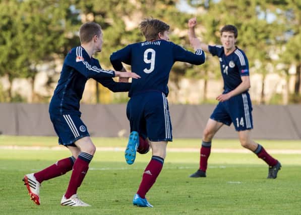 Scotland's Craig Wighton (9) wheels away to celebrate after scoring. Picture: SNS