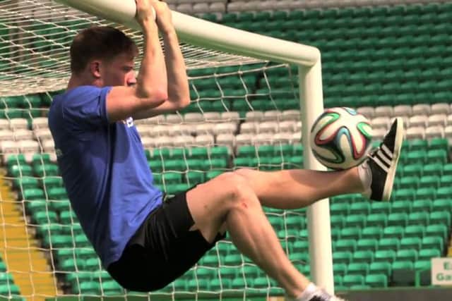 Andrew Henderson hangs off the crossbar at Celtic Park as he juggles the ball with his feet. Picture: Contributed
