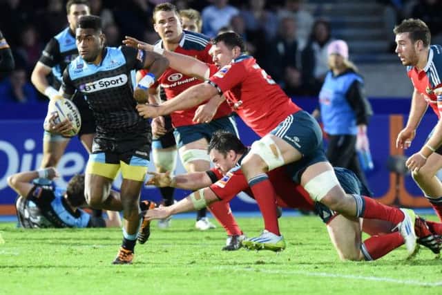 Glasgow Warriors star Niko Matawalu, left, breaks through the Munster defence. Picture: SNS