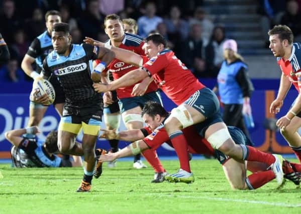 Glasgow Warriors star Niko Matawalu, left, breaks through the Munster defence. Picture: SNS