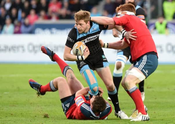 Finn Russell tries to evade the Munster defence. Picture: SNS