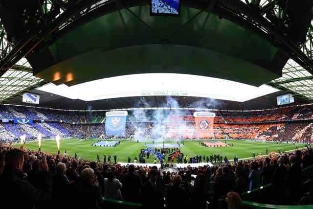 A day with real flare, the two teams enter the arena of Celtic Park. Picture: SNS