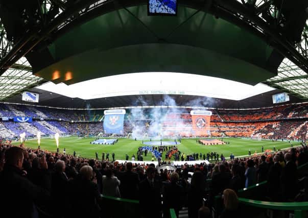 A day with real flare, the two teams enter the arena of Celtic Park. Picture: SNS