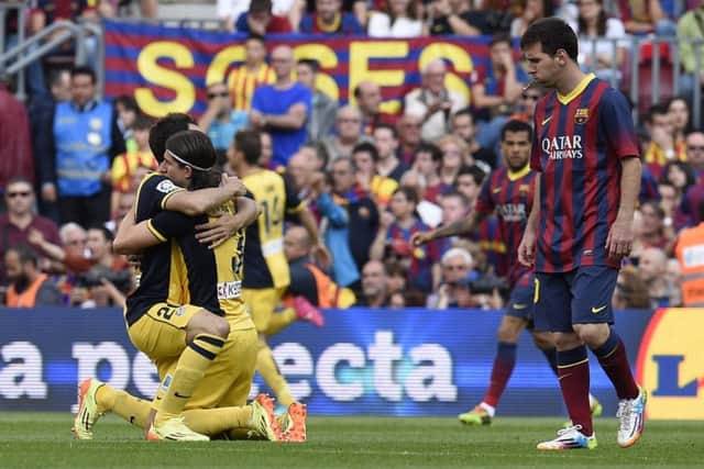 Atletico Madrid midfielder Juanfran, left, embraces team-mate Filipe Luis after clinching the La Liga title. Picture:AFP/Getty