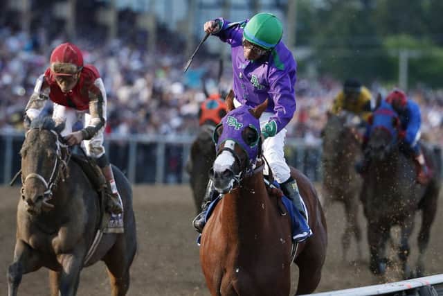 Jockey Victor Espinoza, right, celebrates aboard California Chrome in Baltimore. Picture: Matt Slocum/AP
