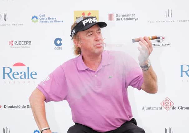 Miguel Angel Jimenez of Spain smokes a cigar as he poses with the trophy. Picture: Getty