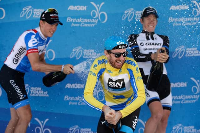 Tour of California champion Sir Bradley Wiggins is sprayed with champagne by Rohan Dennis, left, and Lawson Craddock. Picture: Getty
