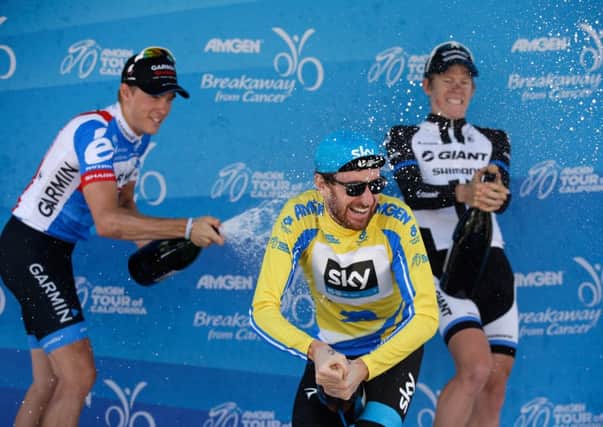 Tour of California champion Sir Bradley Wiggins is sprayed with champagne by Rohan Dennis, left, and Lawson Craddock. Picture: Getty