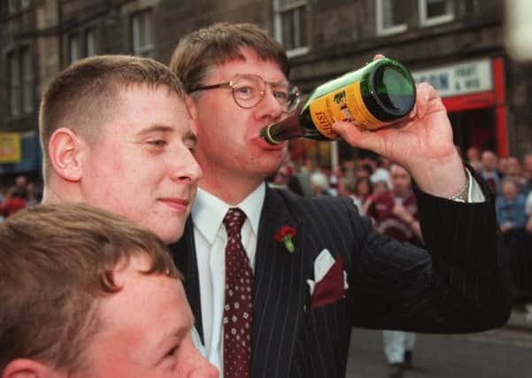 Former Edinburgh Lord Provost Eric Milligan enjoys a wee sip of Buckfast wine. Picture: TSPL