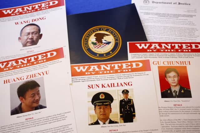 Wanted posters were seen at a press conference about the charges. Picture: AP