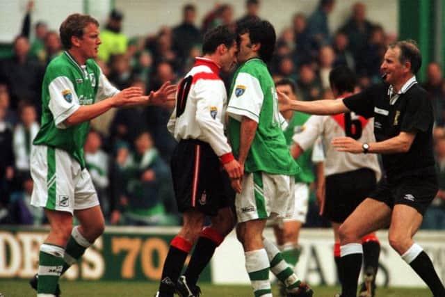 Hibs striker Darren Jackson and Airdries John Davies square up during the match. Picture: Tina Norris