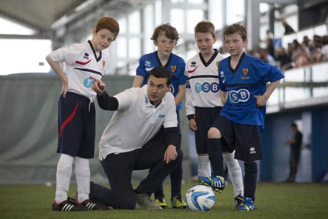 Dumbarton manager Ian Murray has some words of advice for youngsters at Toryglen Regional Football Centre yesterday. Picture: Jeff Holmes