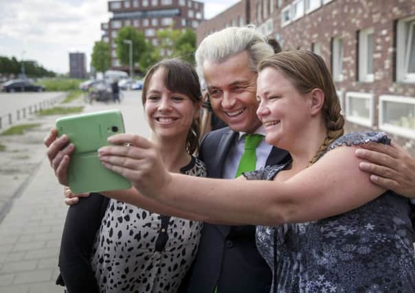 Geert Wilders, leader of the Dutch Party for Freedom, poses for a selfie with voters in the Netherlands. Picture: AP