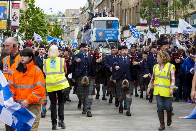 The Scottish Cup winning St Johnstone team is piped past the Perth public