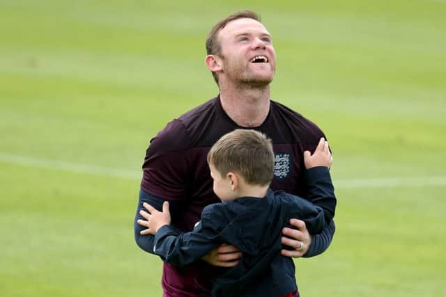 Wayne Rooney hugs his son Kai after training in Portugal. Picture: Getty