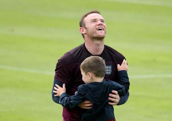 Wayne Rooney hugs his son Kai after training in Portugal. Picture: Getty
