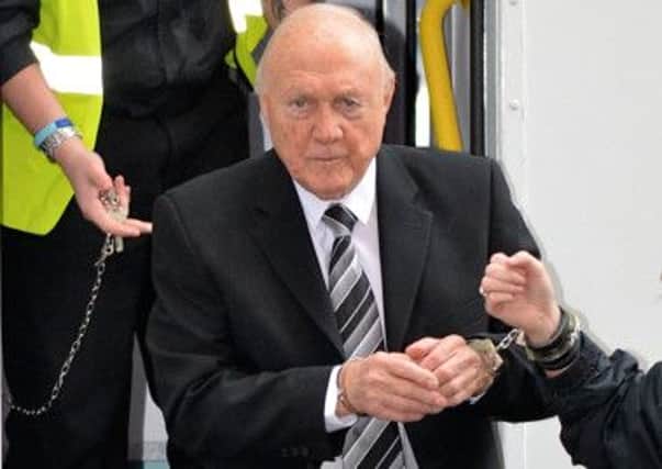 Stuart Hall is led in handcuffs for sentencing. Picture: Warren Smith
