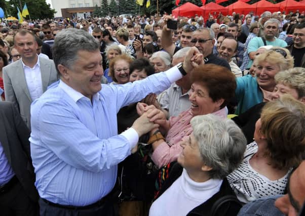 Billionaire confectioner Petro Poroshenko meets prospective voters. Picture: Reuters