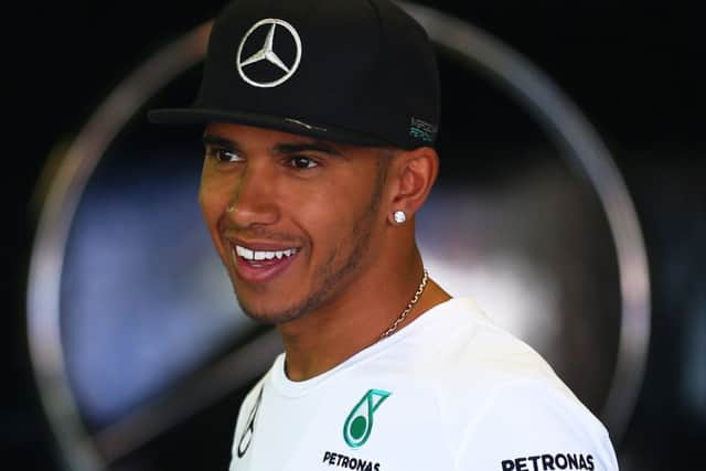 Lewis Hamilton shares a joke in the Mercedes team garage yesterday. Picture: Getty