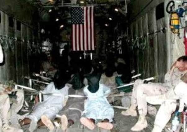 Terrorist suspects are held, hooded and tied up, aboard a US rendition flight. Picture: Contributed