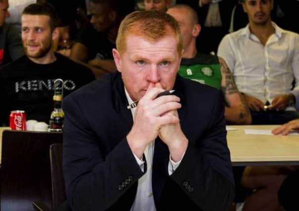 Neil Lennon watches the draw for the Champions League. Picture: SNS