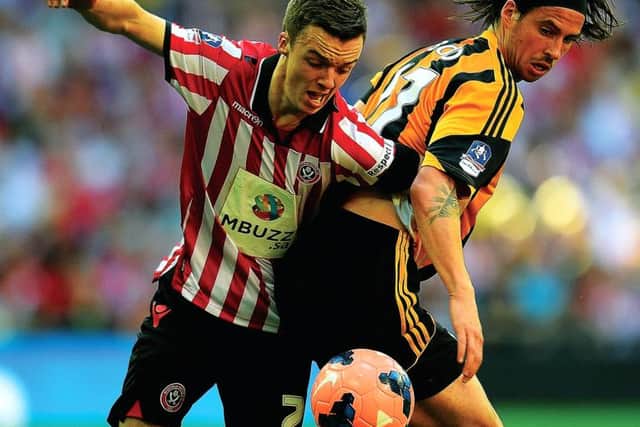 Stefan Scougall of Sheffield United, left, battles with Hulls Scotland international George Boyd. Picture: Getty