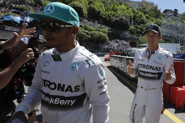 Lewis Hamilton is less than impressed as team-mate Nico Rosberg shows his pleasure. Picture: Luca Bruno