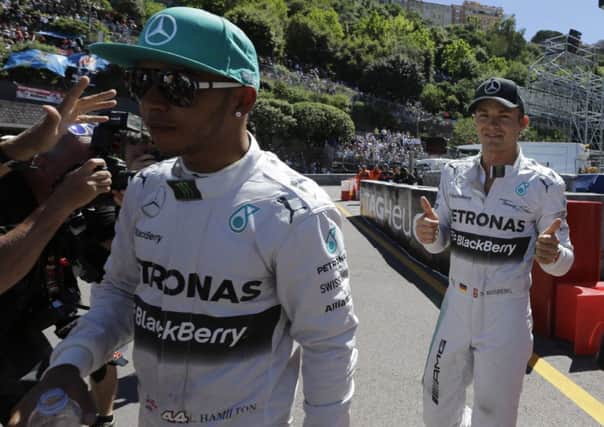 Lewis Hamilton is less than impressed as team-mate Nico Rosberg shows his pleasure. Picture: Luca Bruno