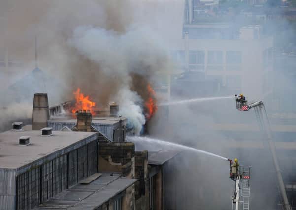 Firefighters tackle the blaze at the iconic Mackintosh building on Friday. Picture: Hemedia