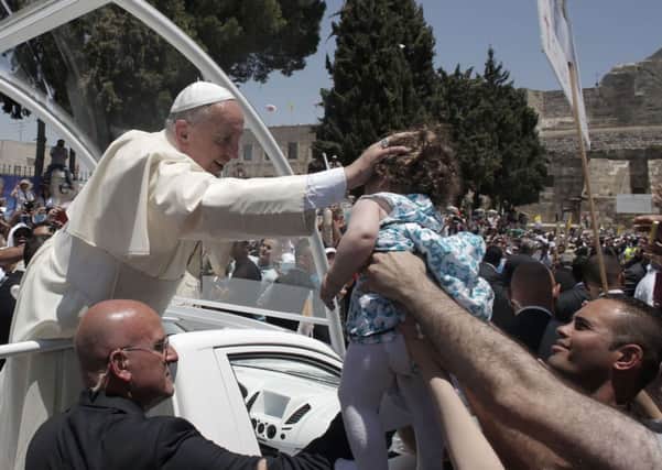 Pope Francis blesses a child following the Mass in Manager Square, Bethlehem. Picture: Getty