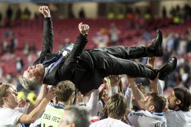 Jubilant Real Madrid coach Carlo Ancelotti is hoisted into the air by his elated stars.  Picture: SNS