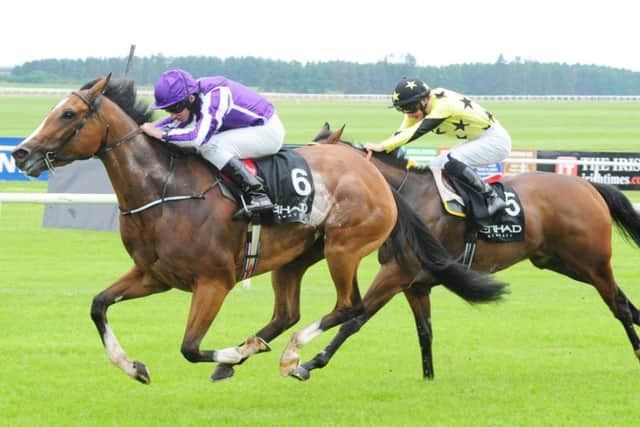 Marvellous (left), ridden by Ryan Moore, wins the Etihad Airways Irish 1000 Guineas. Picture: PA
