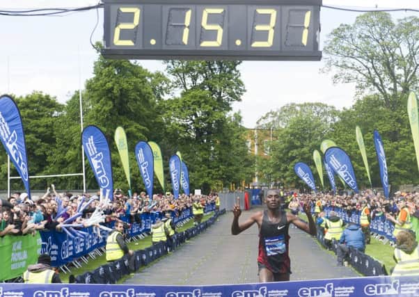 David Toniok from Kenya is the first to cross the finish line in the Edinburgh marathon. Picture: SNS