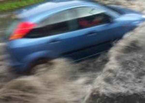 A motorist caught in floods in Edinburgh yesterday. Picture: Contributed