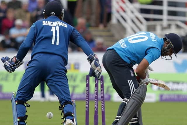 Sri Lankas Kumar Sangakkara (left) looks on as Englands Ravi Bopara is bowled out. Picture: Getty