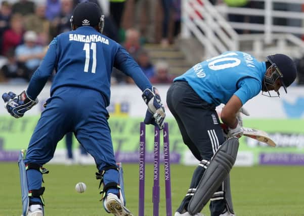 Sri Lankas Kumar Sangakkara (left) looks on as Englands Ravi Bopara is bowled out. Picture: Getty
