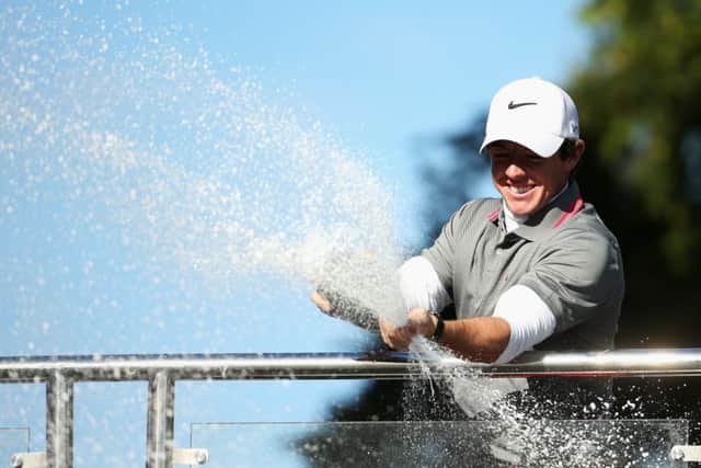 A jubilant Rory Mcllroy sprays champagne following his victory. Picture: Getty