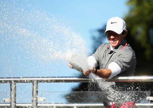 A jubilant Rory Mcllroy sprays champagne following his victory. Picture: Getty