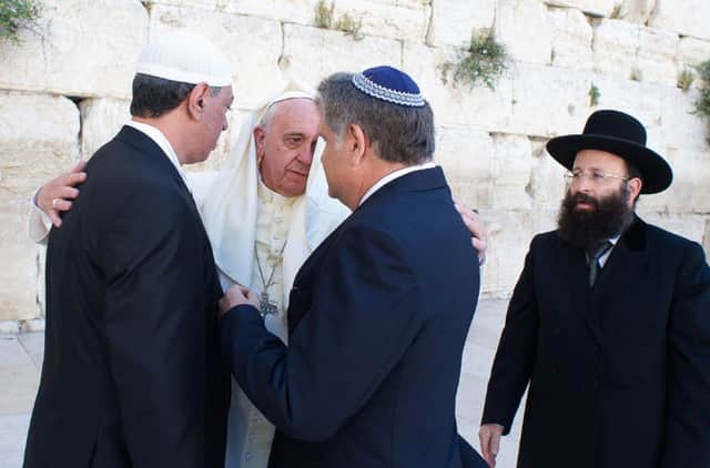 Pope Francis embraces friends,  an imam and a rabbi, at the Western Wall in Jerusalem. Picture: Getty Images