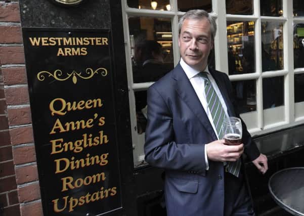 Nigel Farage savours a pint of beer, and Ukips success, as he prepares to face the media in London yesterday. Picture: Getty