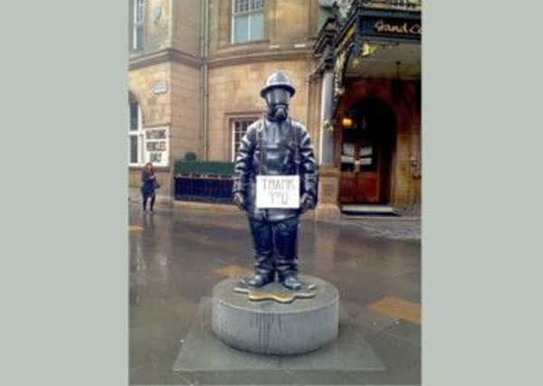 An anonymous tribute for fire crews is seen on the Citizen Firefighter statue in Glasgow. Picture: GSA/Facebook