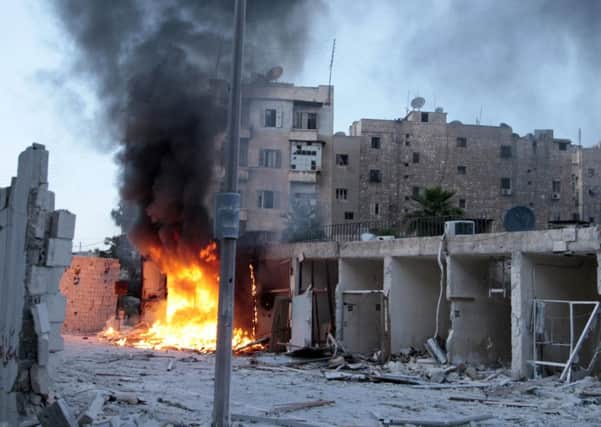 Flames erupt from a site hit by a bomb in Aleppo, Syria. Picture: Reuters