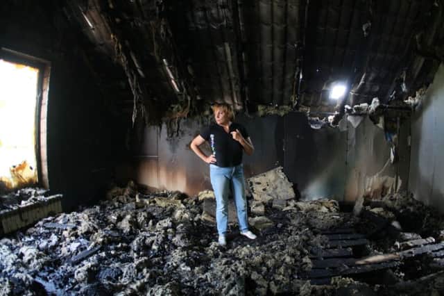 A woman surveys the debris of her burnedout apartment, destroyed during fighting for Donetsk airport on Monday. Picture: Getty